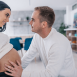 Husband touching his wife pregnant belly