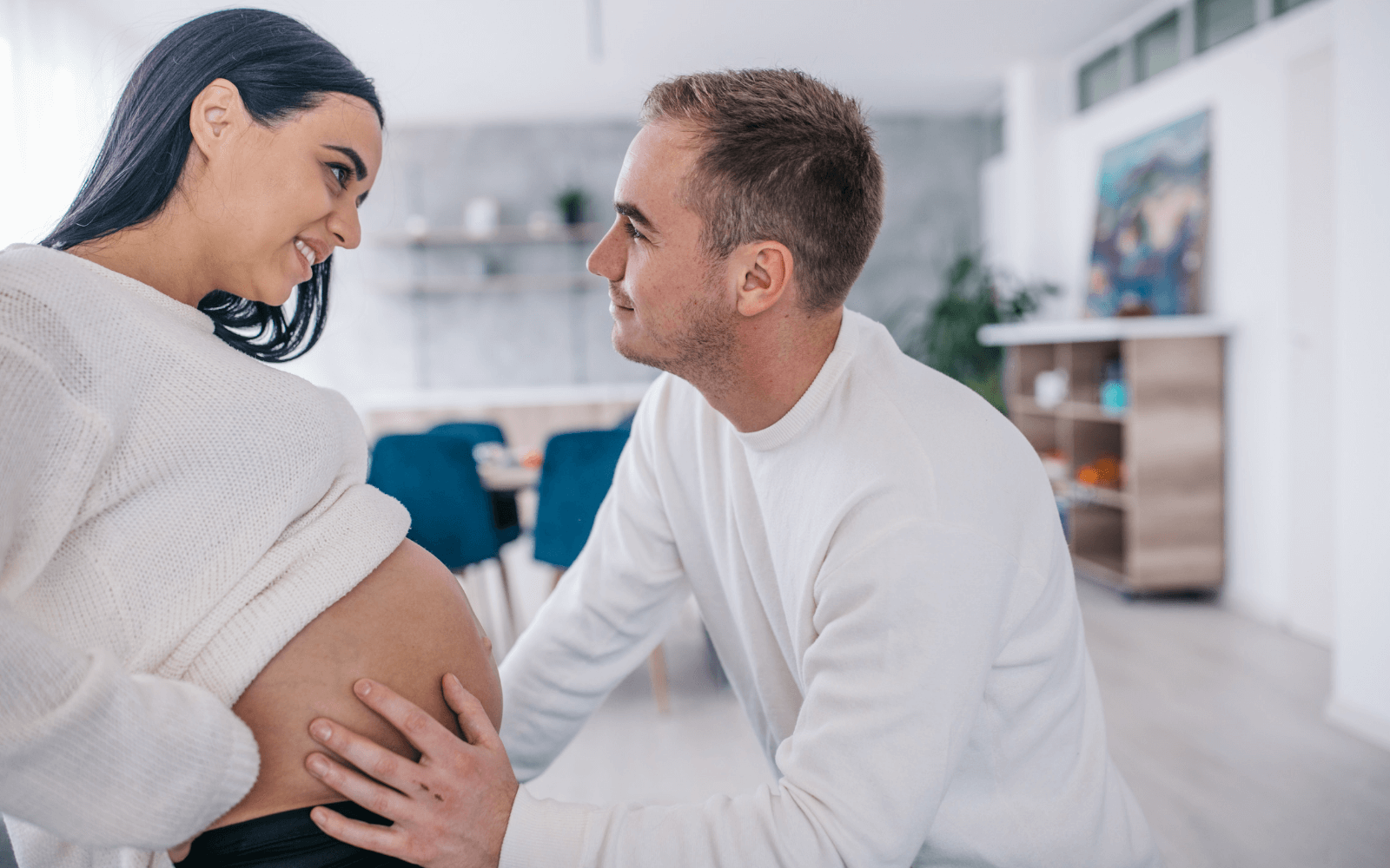 Husband touching his wife pregnant belly