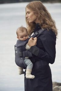 Mom wearing her baby in a Soft structured carrier 