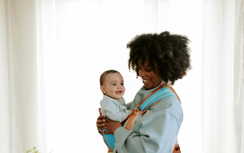 Mom wearing her baby in a ring sling baby carrier