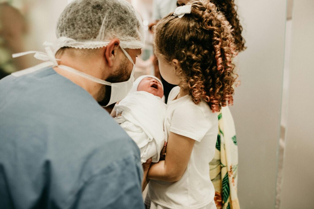 Older sister meeting her newborn sibling for the first time