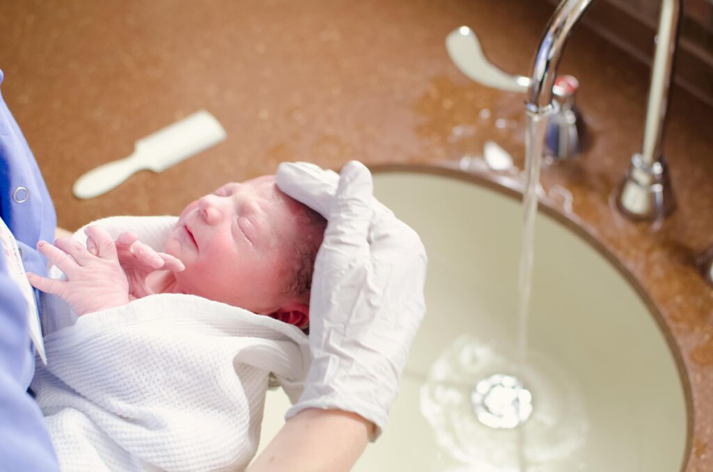 baby's first bath in the sink