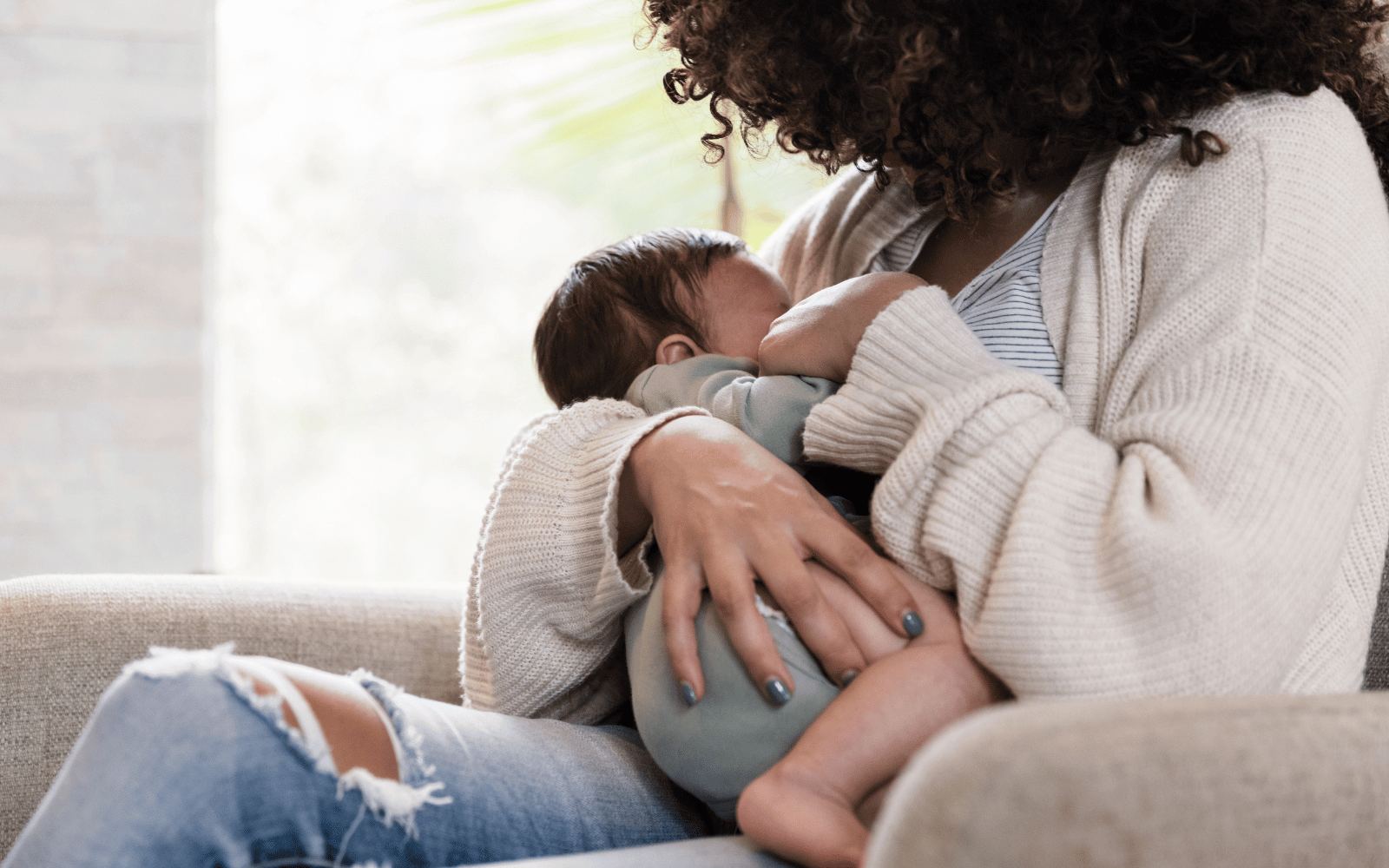 mom breatfeeding her baby in cradle hold