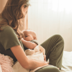 mom breastfeeding her baby in a cradle hold