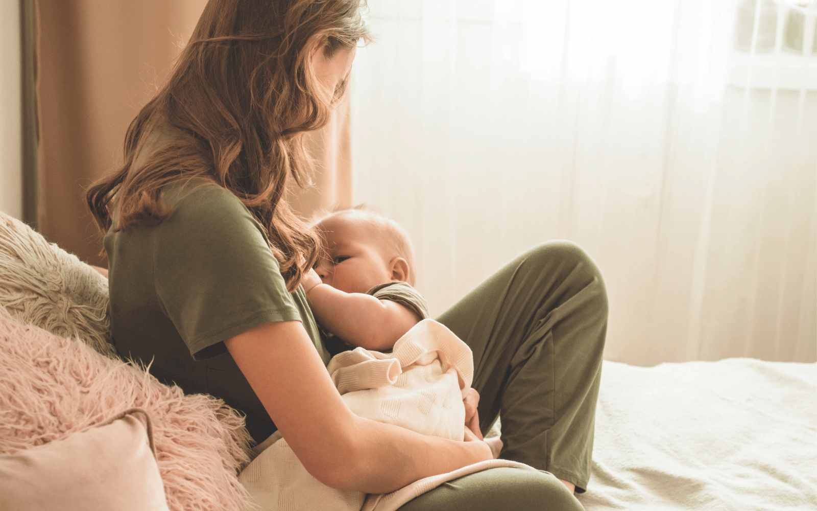 mom breastfeeding her baby in a cradle hold