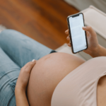 pregnent mom making baby registry in her smartphone