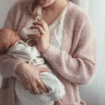 mom feeding her baby formula with a bottle