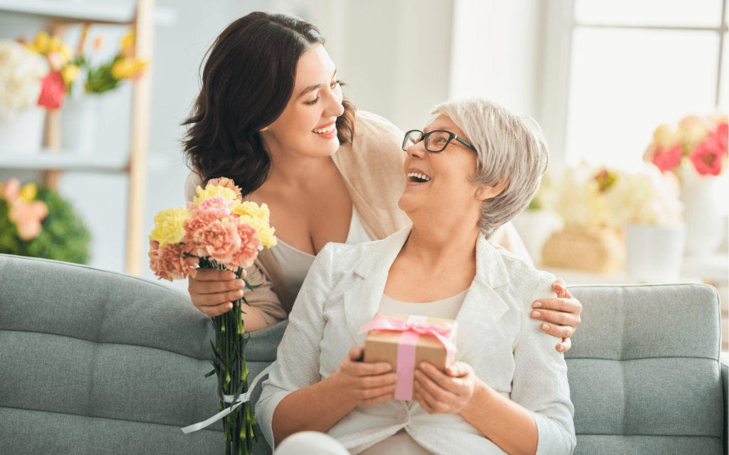 Daughter giving a mothers day gift to her mother