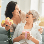 Daughter giving a mothers day gift to her mother
