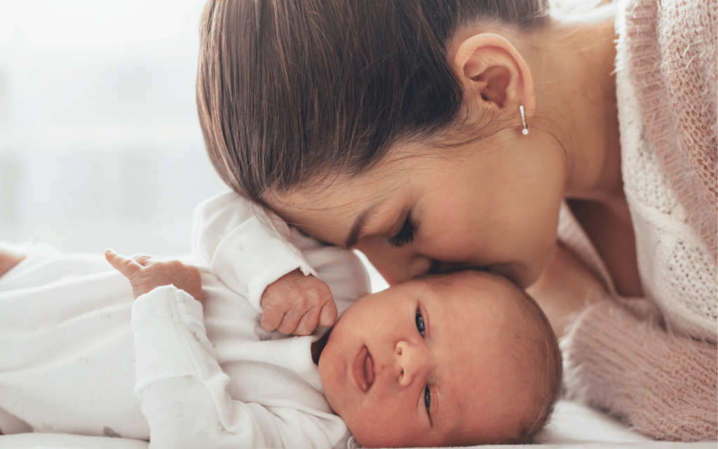 new mom kissing her baby