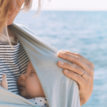 mom is wearing her baby in a wrap carrier