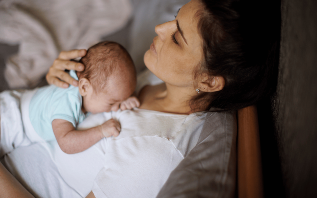 postpartum mom with her newborn baby