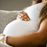 pregnent woman puting her hand on her belly