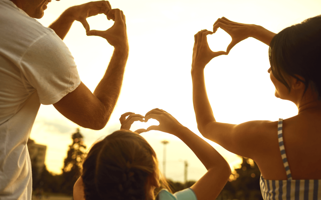 A family sigining hearts with their hands