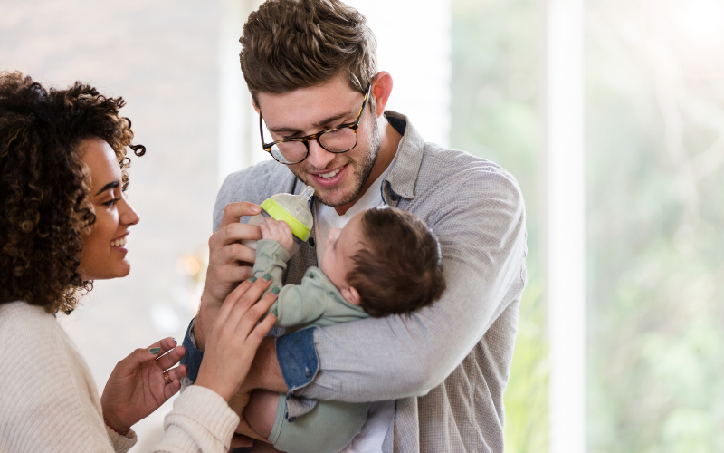 Dad feeding the baby with expressed breast milk