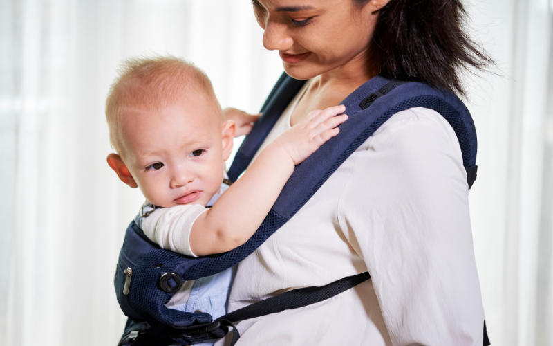 mom wearing her baby with a soft structured carrier