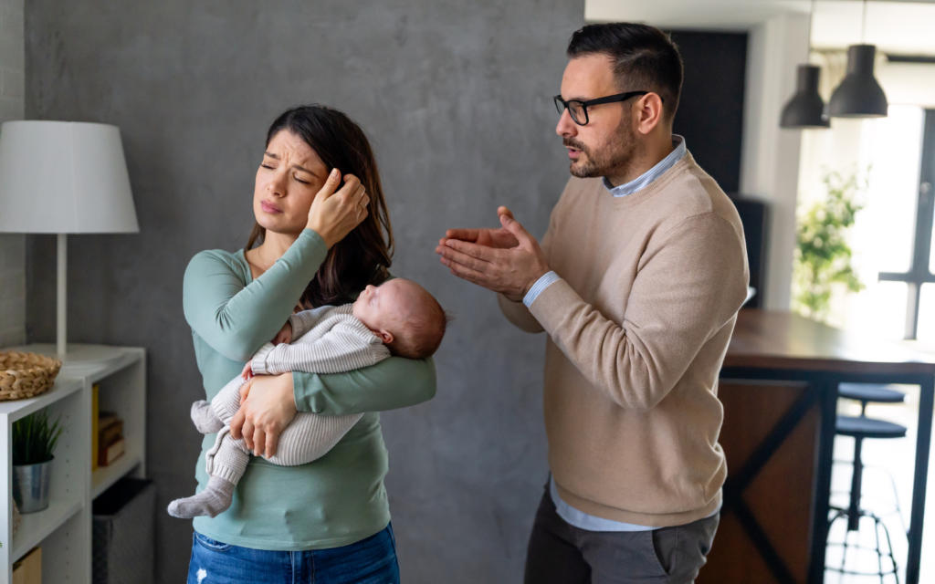 Couple fighting while mom holding the baby