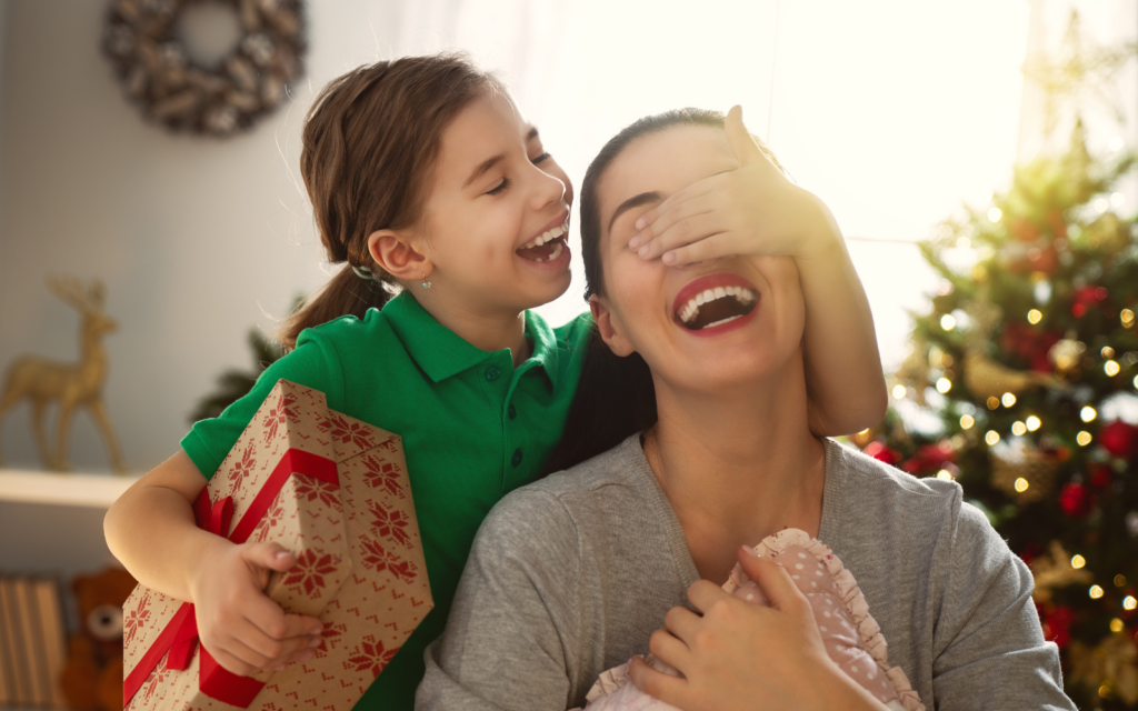 Kid giving gift to her mother