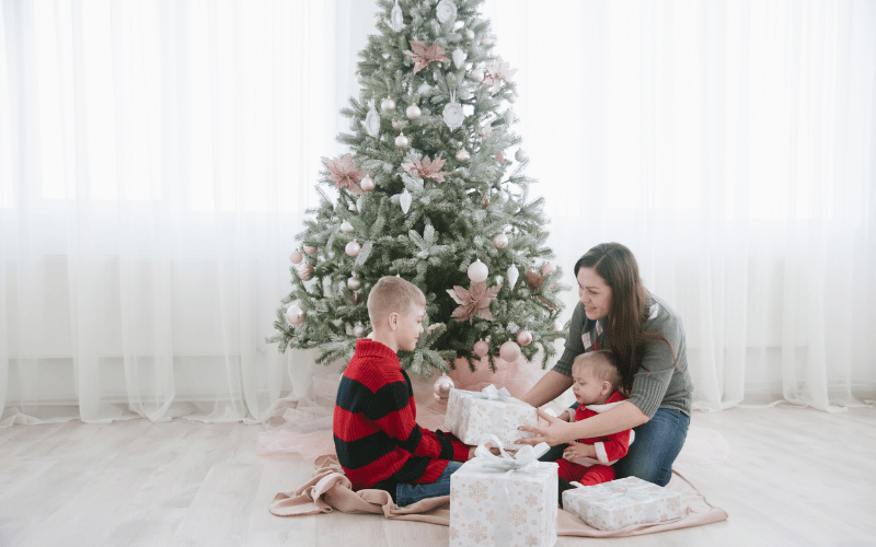 Mom and kids next to the christmas tree