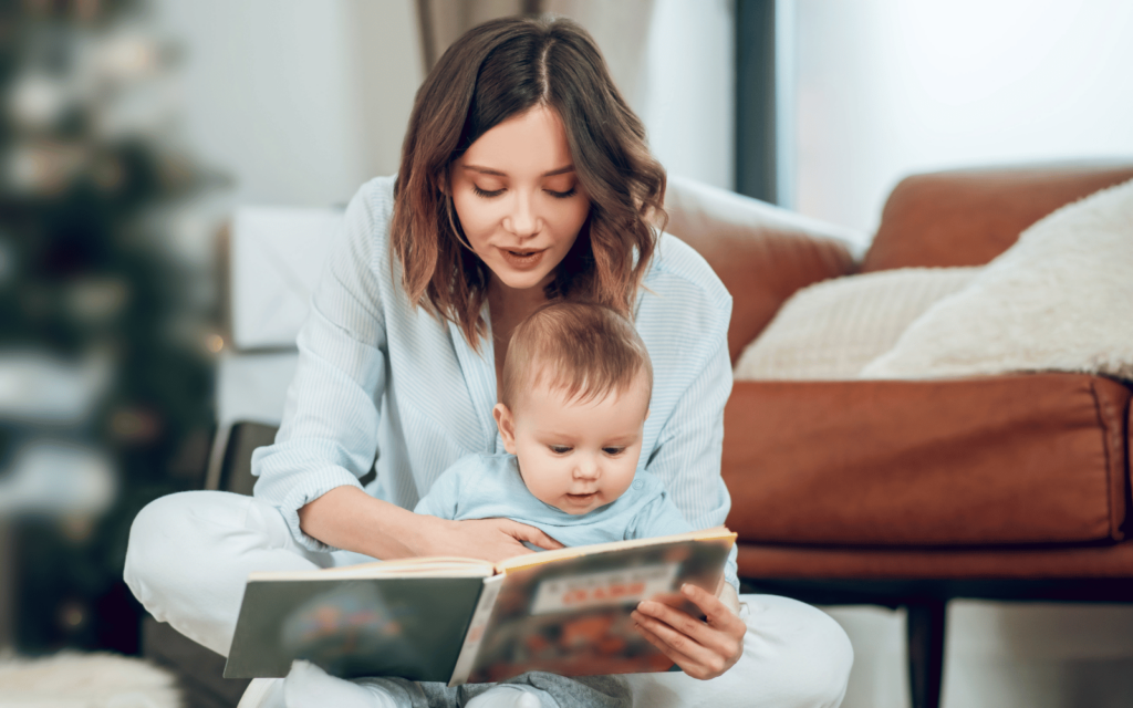 mom is reading a book to her baby