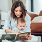 mom is reading a book to her baby