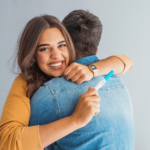 Woman hugging her husband after announcing she is pregnant