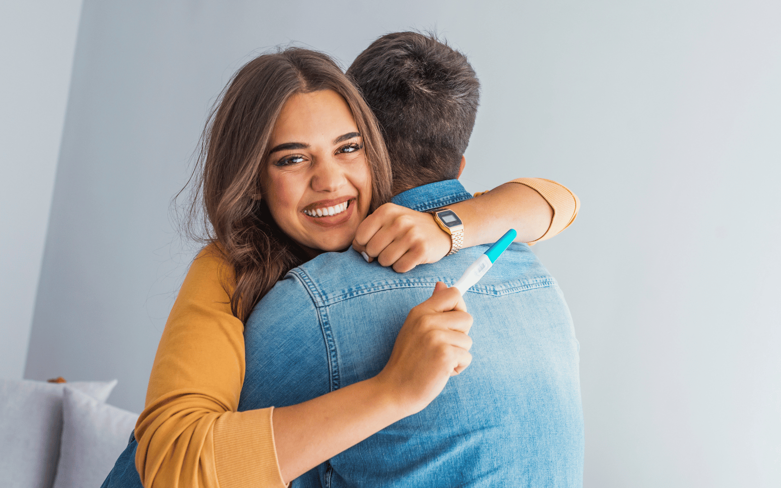 Woman hugging her husband after announcing she is pregnant