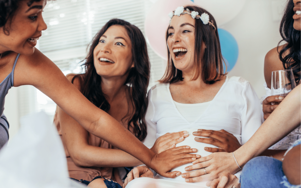 Women laughing at The Funniest Baby Shower Games Ever