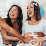 Women laughing at The Funniest Baby Shower Games Ever