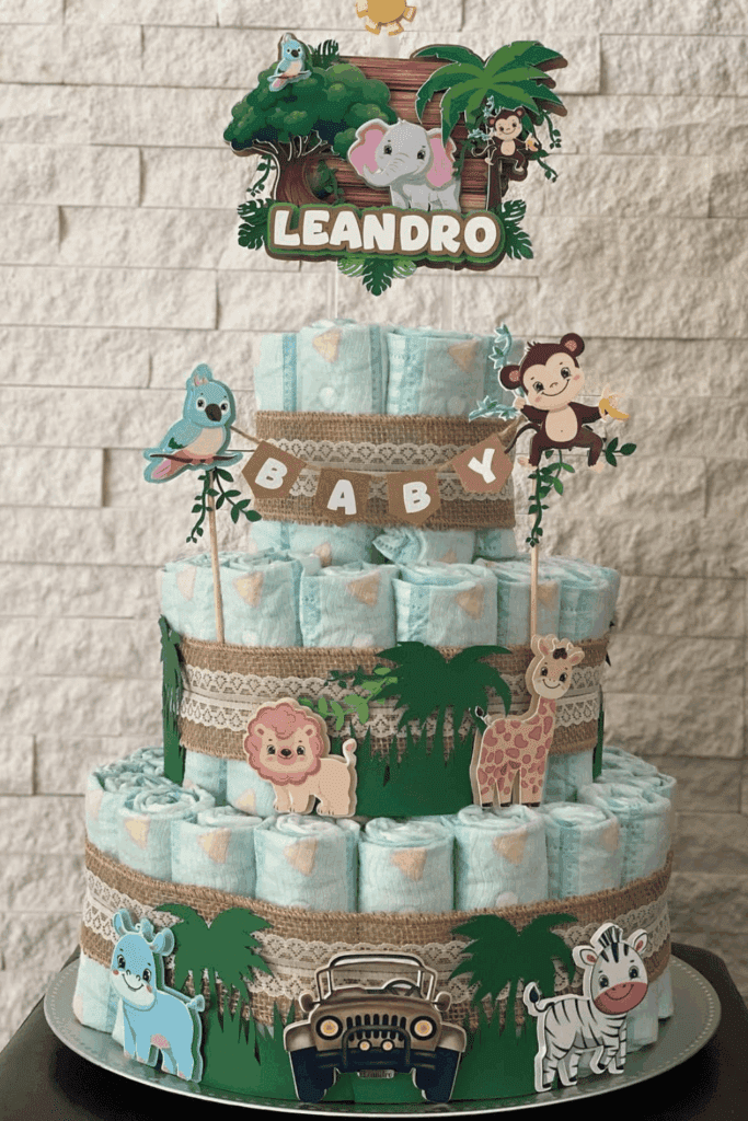 jungle-themed diaper cake features adorable animal cutouts, lush green foliage, and a personalized topper