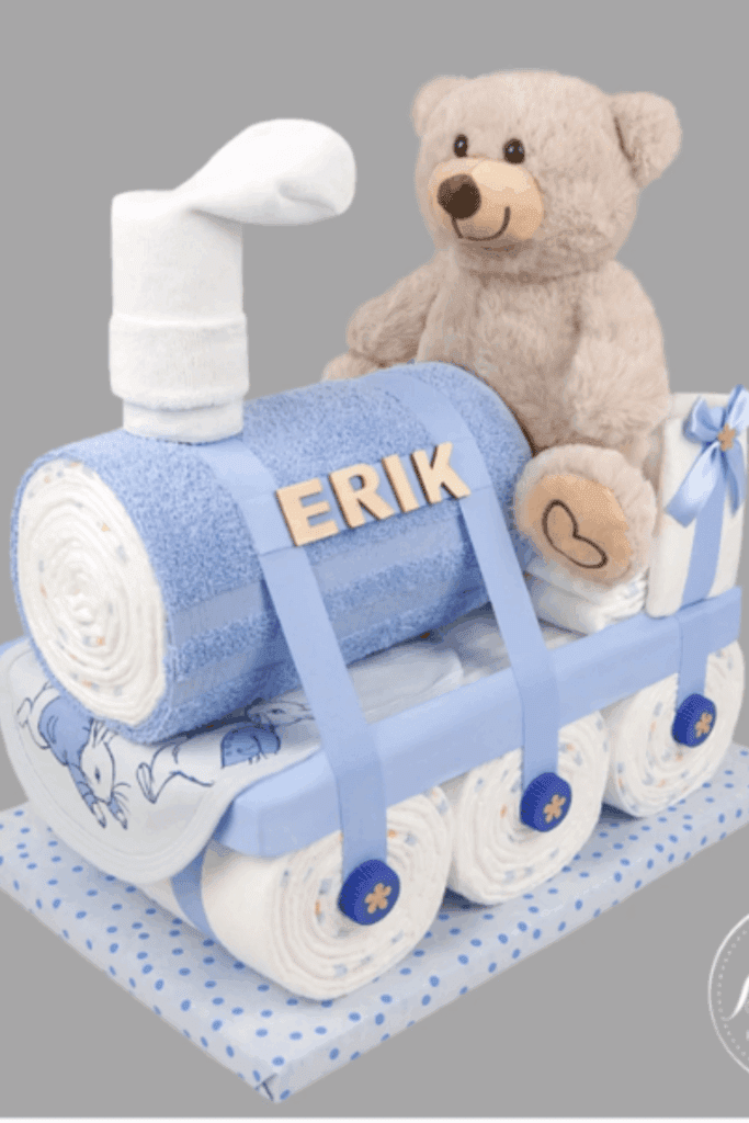  train-shaped diaper cake, featuring the baby name and cuddly teddy bear
