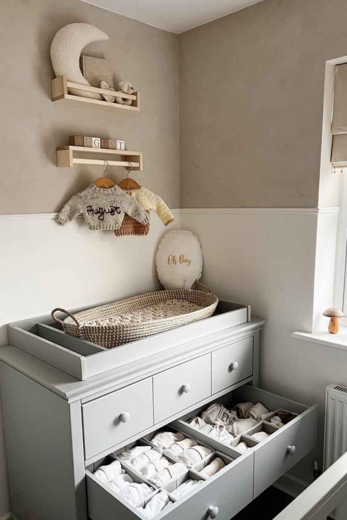 a dresser with a changing topper on top